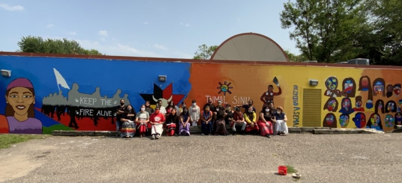 Youth from Ikidowin Youth Theater Ensemble in front of the mural they painted